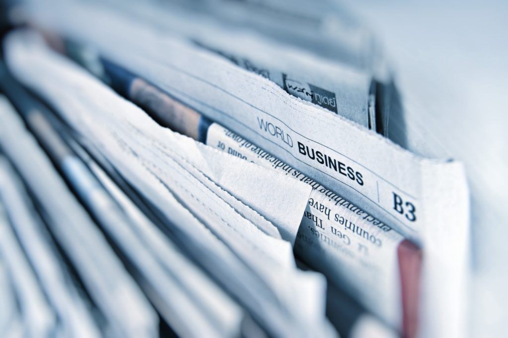 Close up view of folded newspaper with the B3 section in focus titled "World Business"